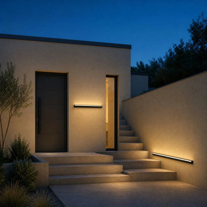 Dovlin outdoor LED wall light lit along a façade and staircase at dusk | Wickleigh