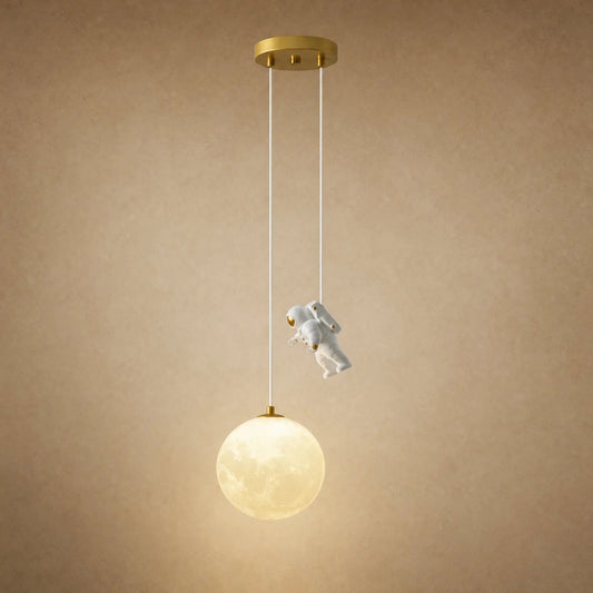 Tevrin moon pendant light, moon globe and astronaut figure on a beige mineral backdrop | Wickleigh