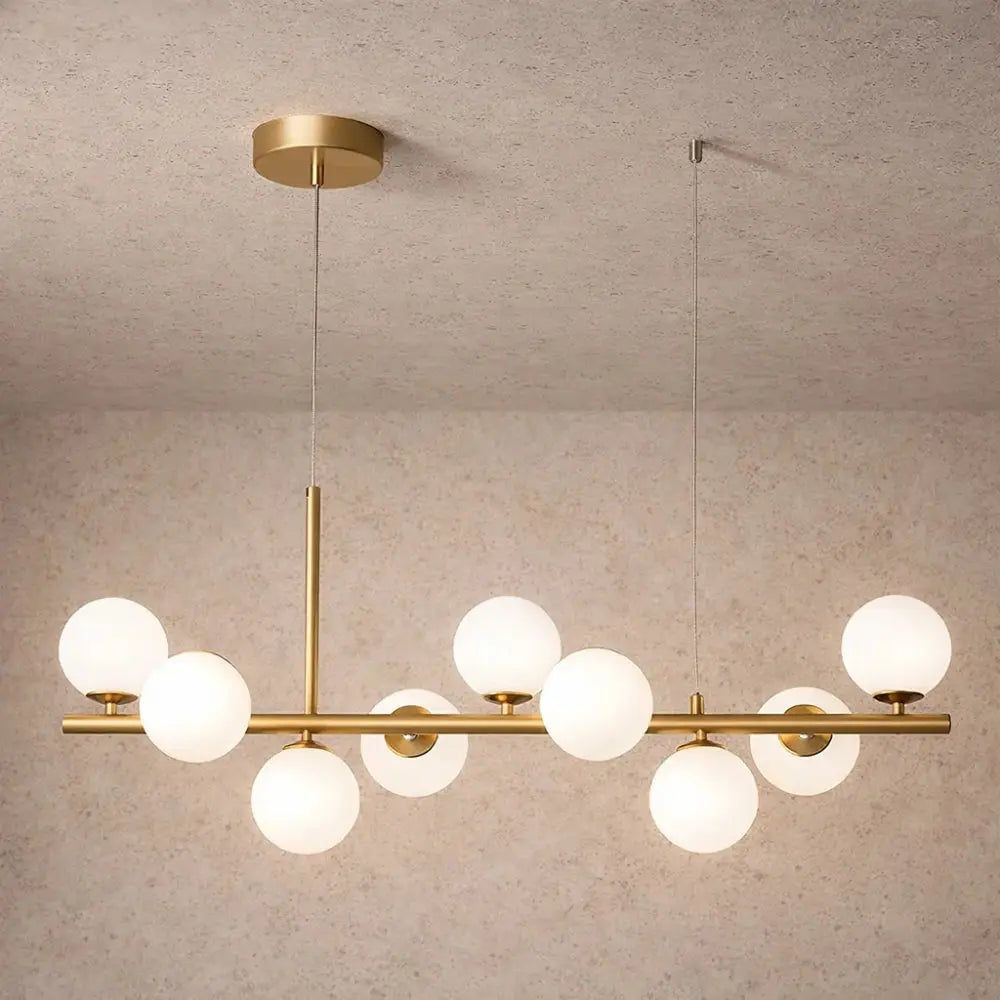 Odvin linear pendant light, glass globe row above dining table, packshot | Wickleigh