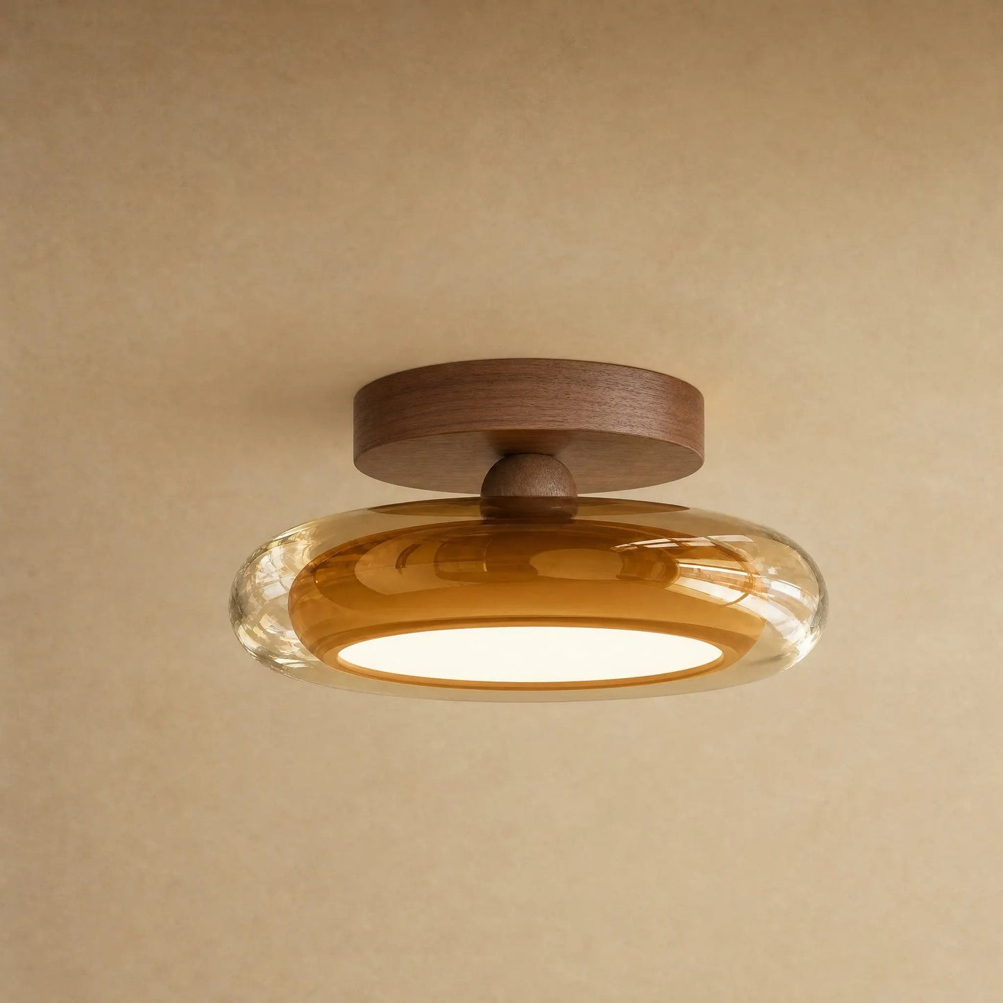 Aswyn ceiling light in amber glass with walnut-effect base plate, glass pebble | Wickleigh