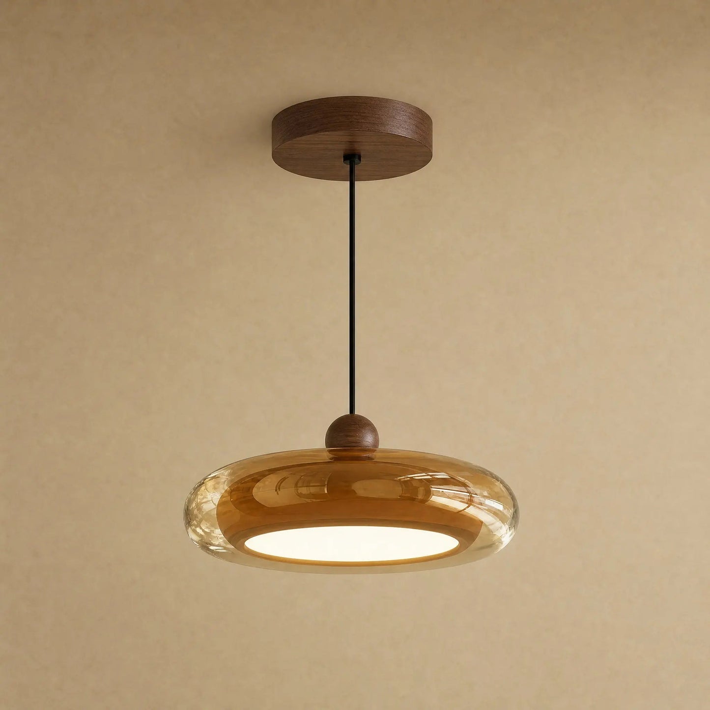 Aswyn pendant light in amber glass with walnut-effect base plate | Wickleigh