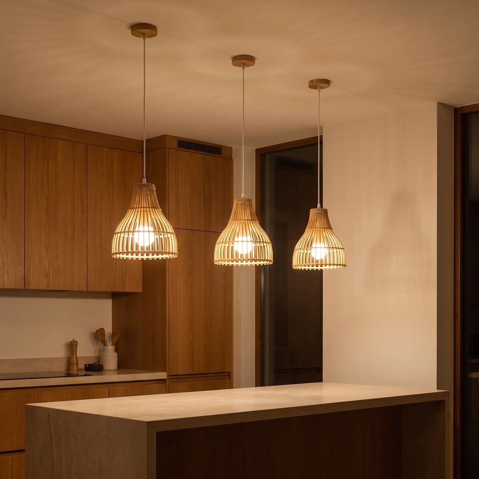 Edika bamboo kitchen pendant light, trio above the island in the evening | Wickleigh