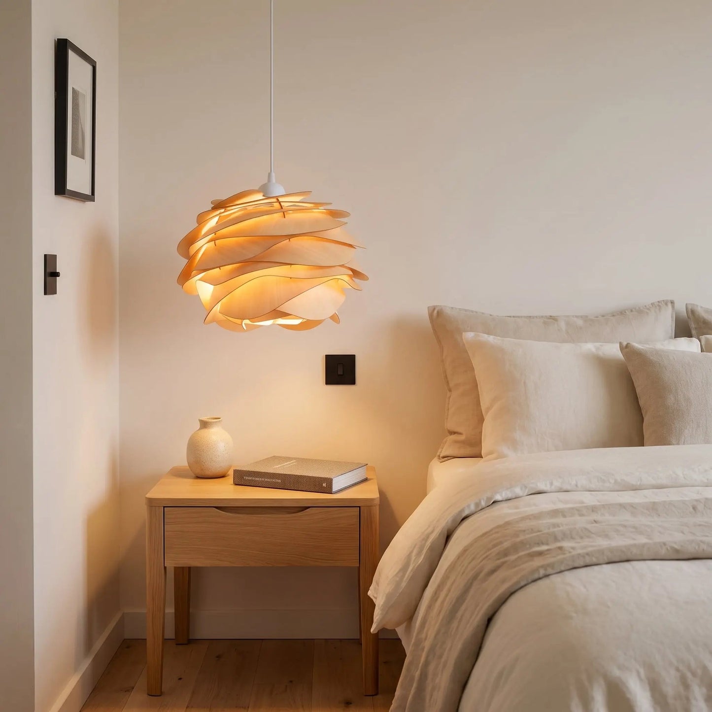 Henlin sculpted wood pendant light lighting a bedside table in a bedroom | Wickleigh