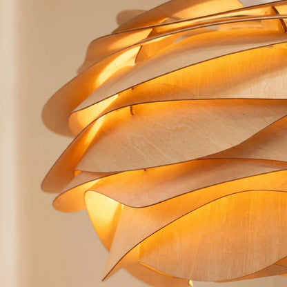 Detail of the Henlin sculpted wood pendant light's wooden petals, lit | Wickleigh
