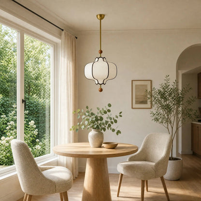 Linne vintage pendant light above a round table in a bright dining corner | Wickleigh