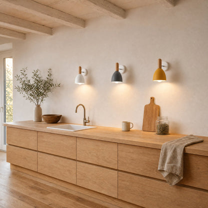 Three Milna Scandinavian wall lights in white, grey and yellow aligned above an oak worktop | Wickleigh