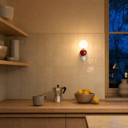 Brelin red and white ball wall light lit above a cream zellige splashback | Wickleigh