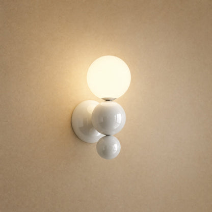 Brelin white ball wall light, cluster of three lacquered beads and lit opal globe | Wickleigh