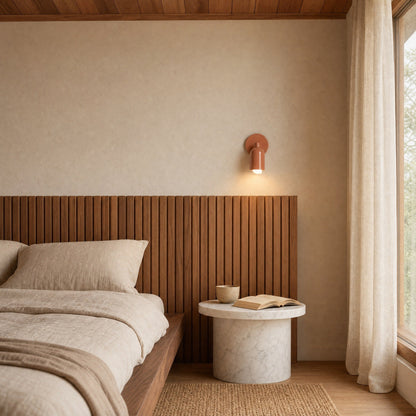 Cadren terracotta wall light lit at the bedside in a Japandi bedroom | Wickleigh