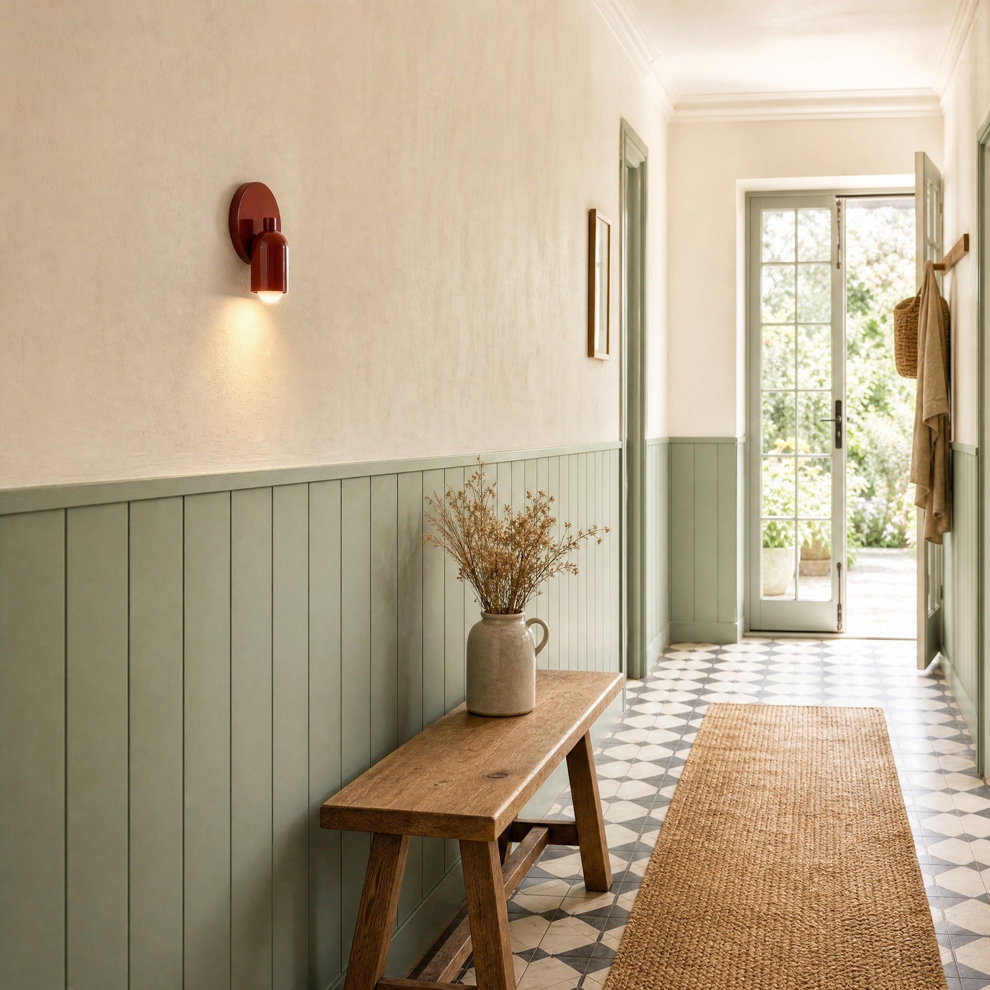 Cadren brick red hallway wall light lit against sea-green panelling | Wickleigh