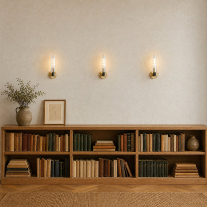 Three Calin wall lights lit in a row above an oak shelf, library hallway | Wickleigh