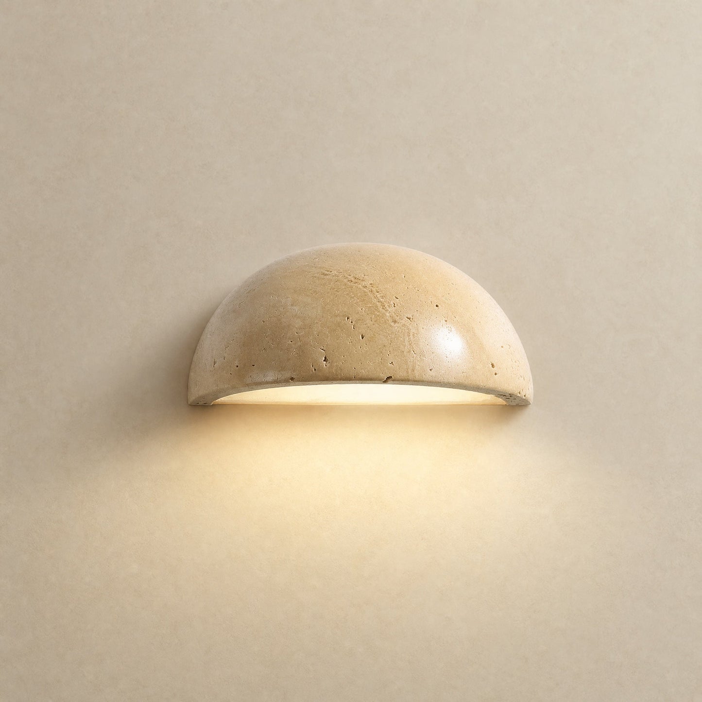 Calvra half-moon wall light lit, natural travertine dome Ø 15 cm | Wickleigh