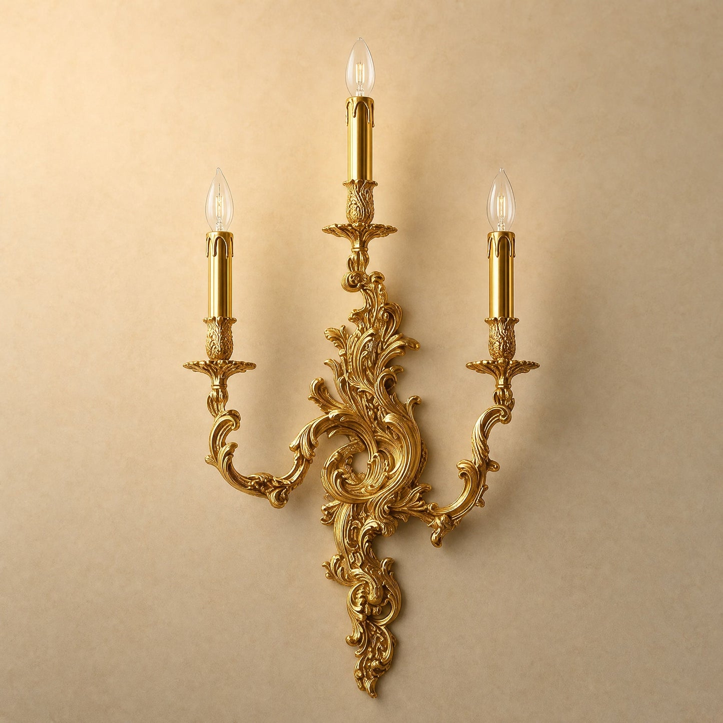 Cerna gold candle wall light, three-candle rococo design, packshot on sand background | Wickleigh