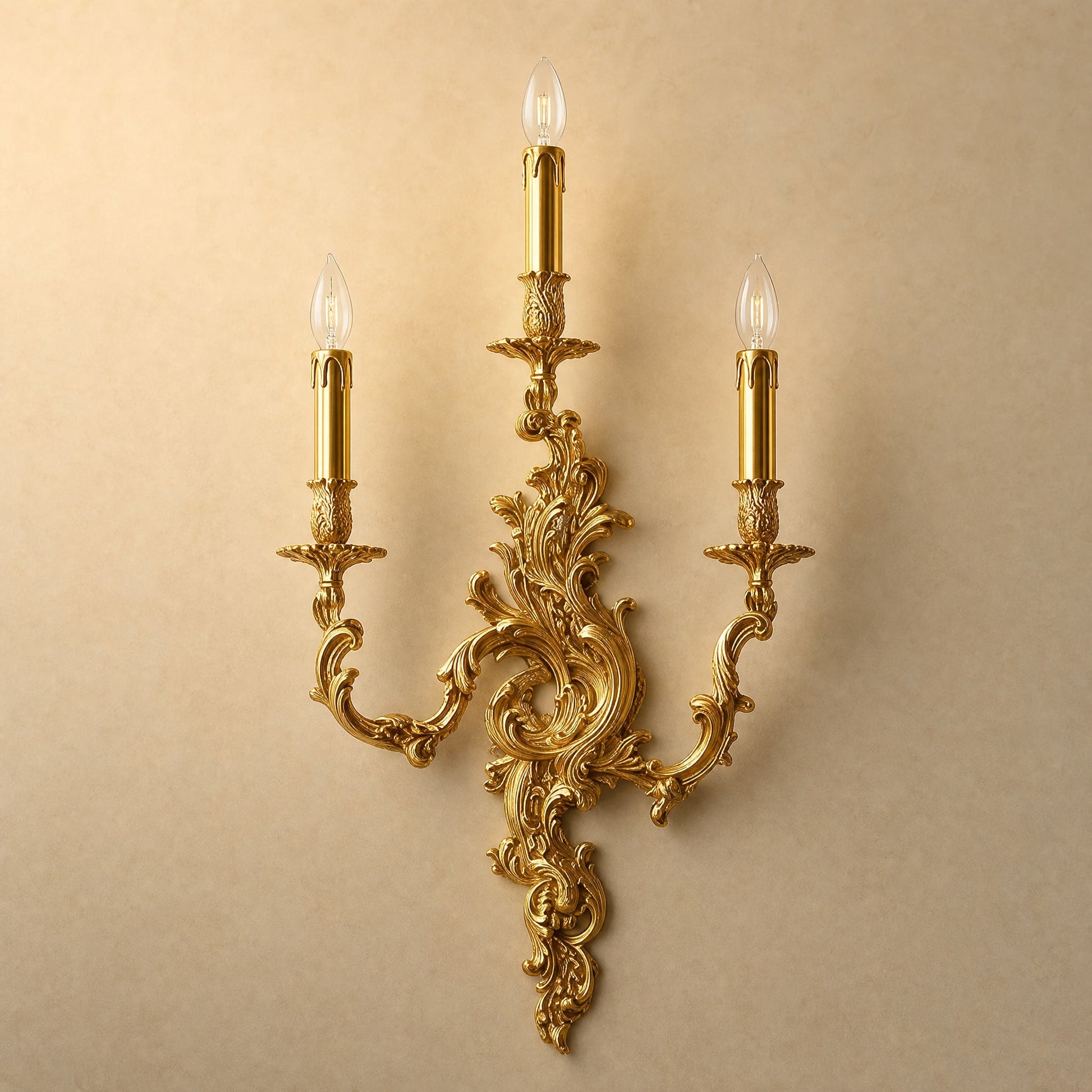 Cerna gold candle wall light, three-candle rococo design, packshot on sand background | Wickleigh