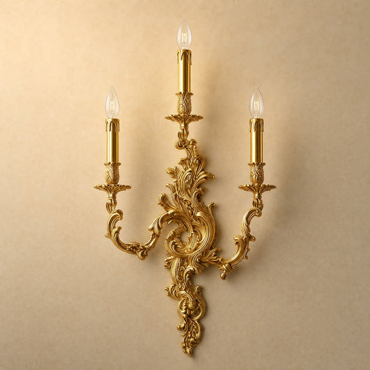 Cerna gold candle wall light, three-candle rococo design, packshot on sand background | Wickleigh