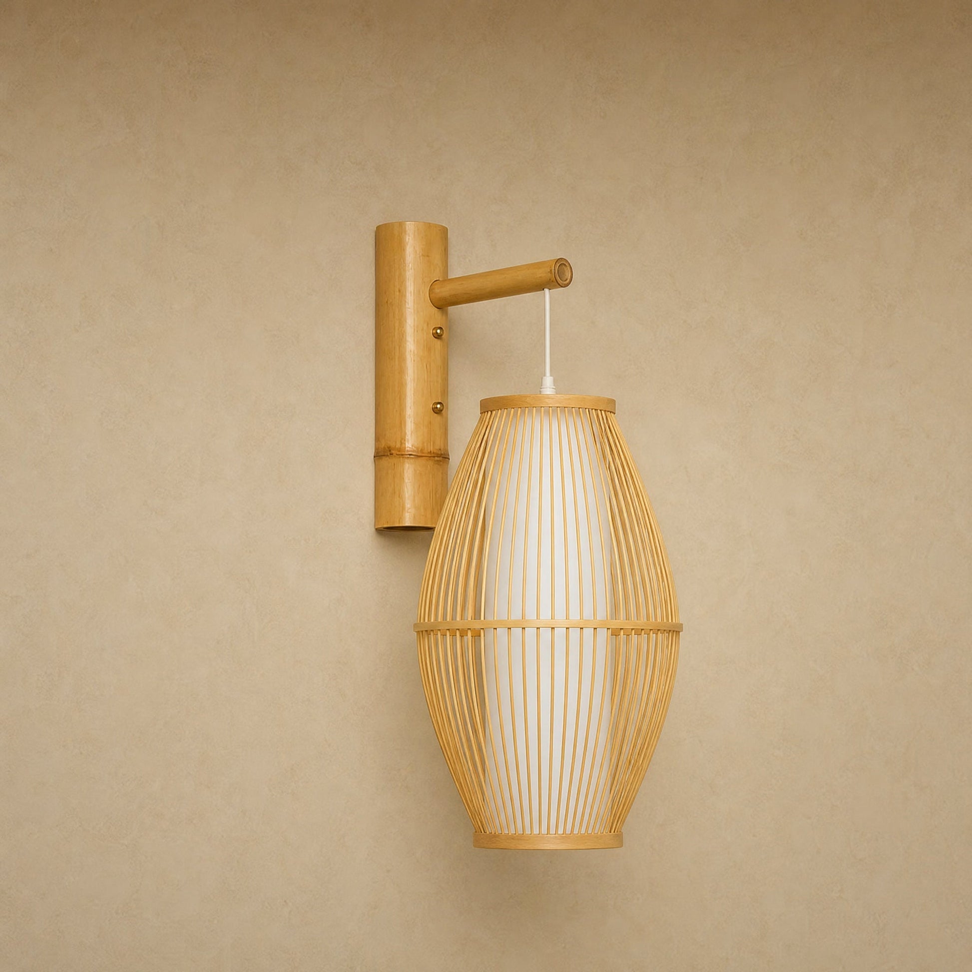 Halna natural wall light, woven bamboo cocoon on a wall arm, front view | Wickleigh