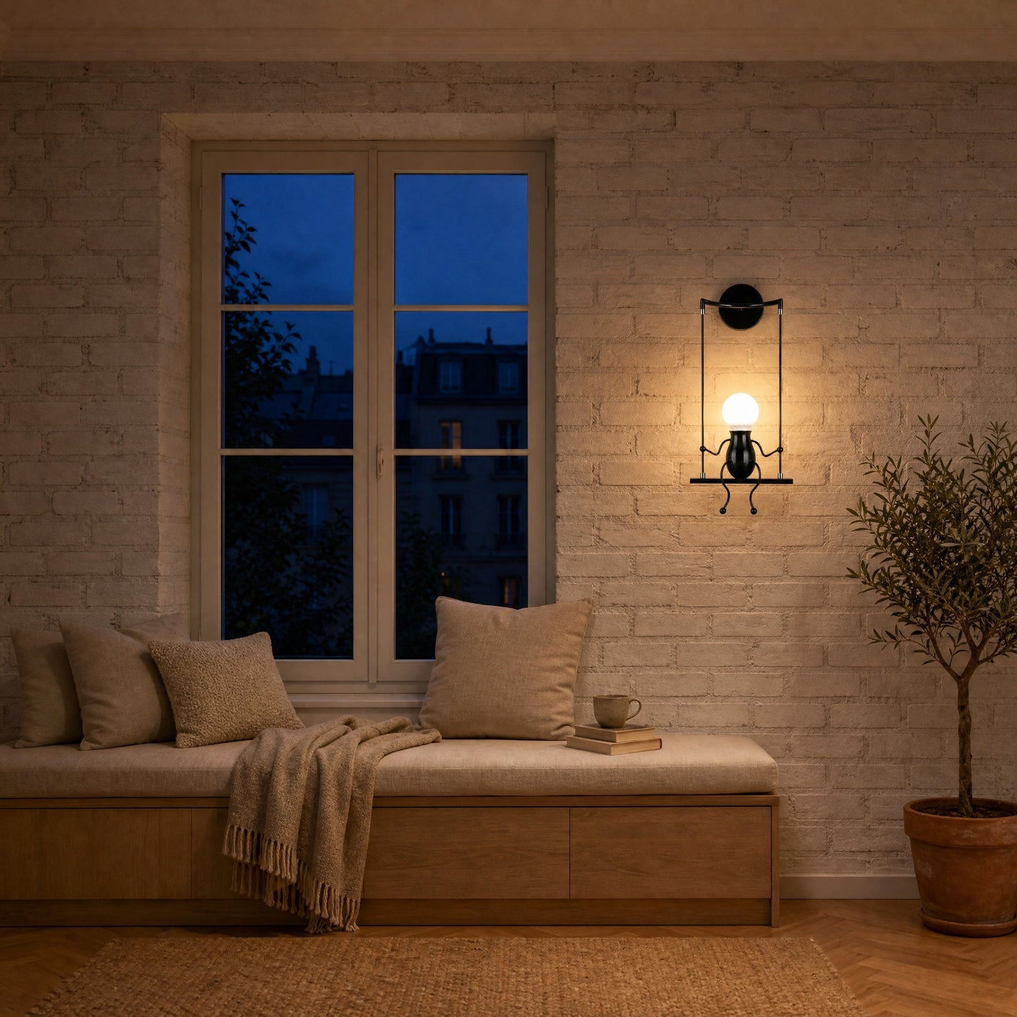 Jyllen black wall light lit in a reading corner with painted brick wall, oak window seat | Wickleigh