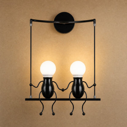 Jyllen black wall light, two figures hand in hand on their swing | Wickleigh