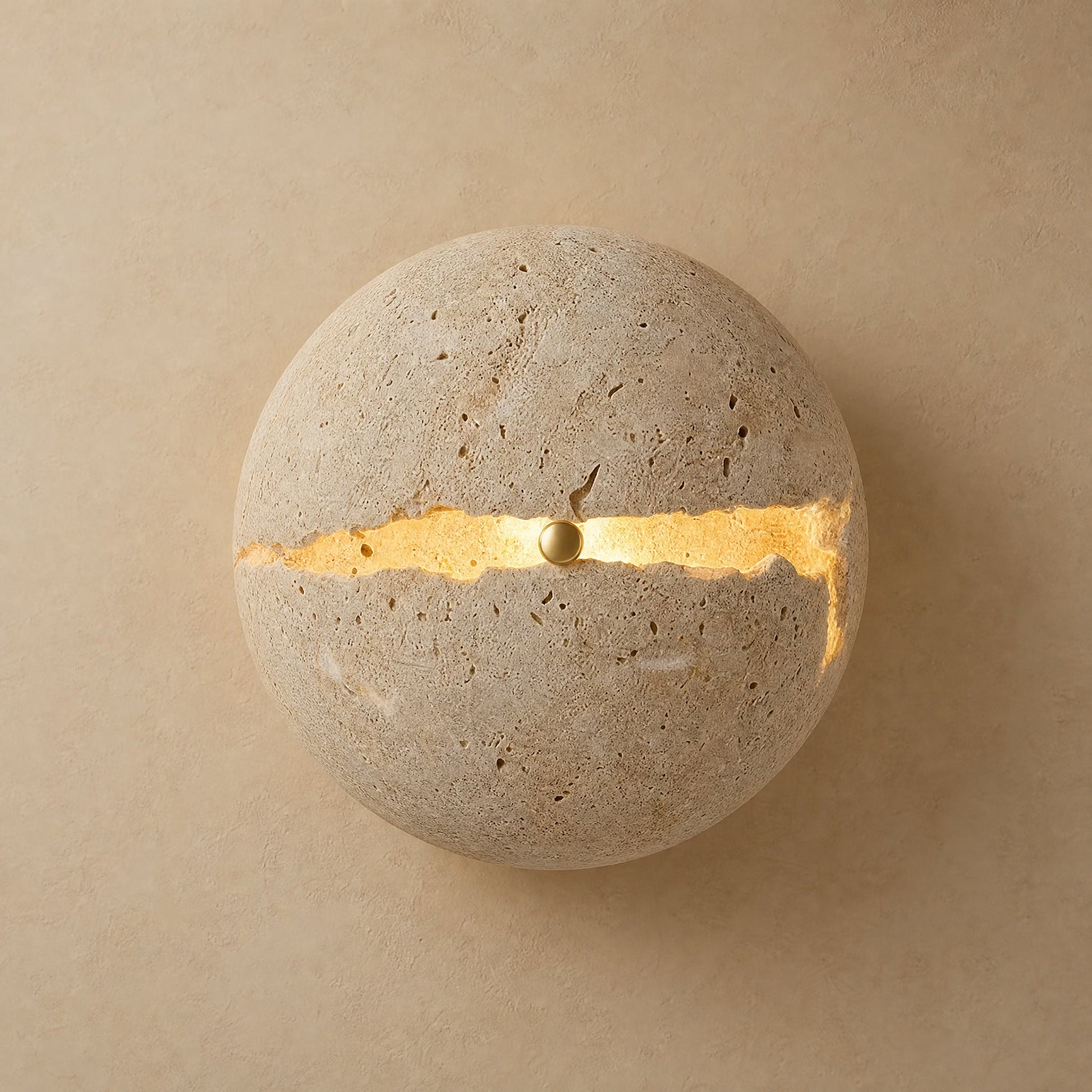 Rinen stone wall light, split yellow travertine sphere with a line of golden light | Wickleigh
