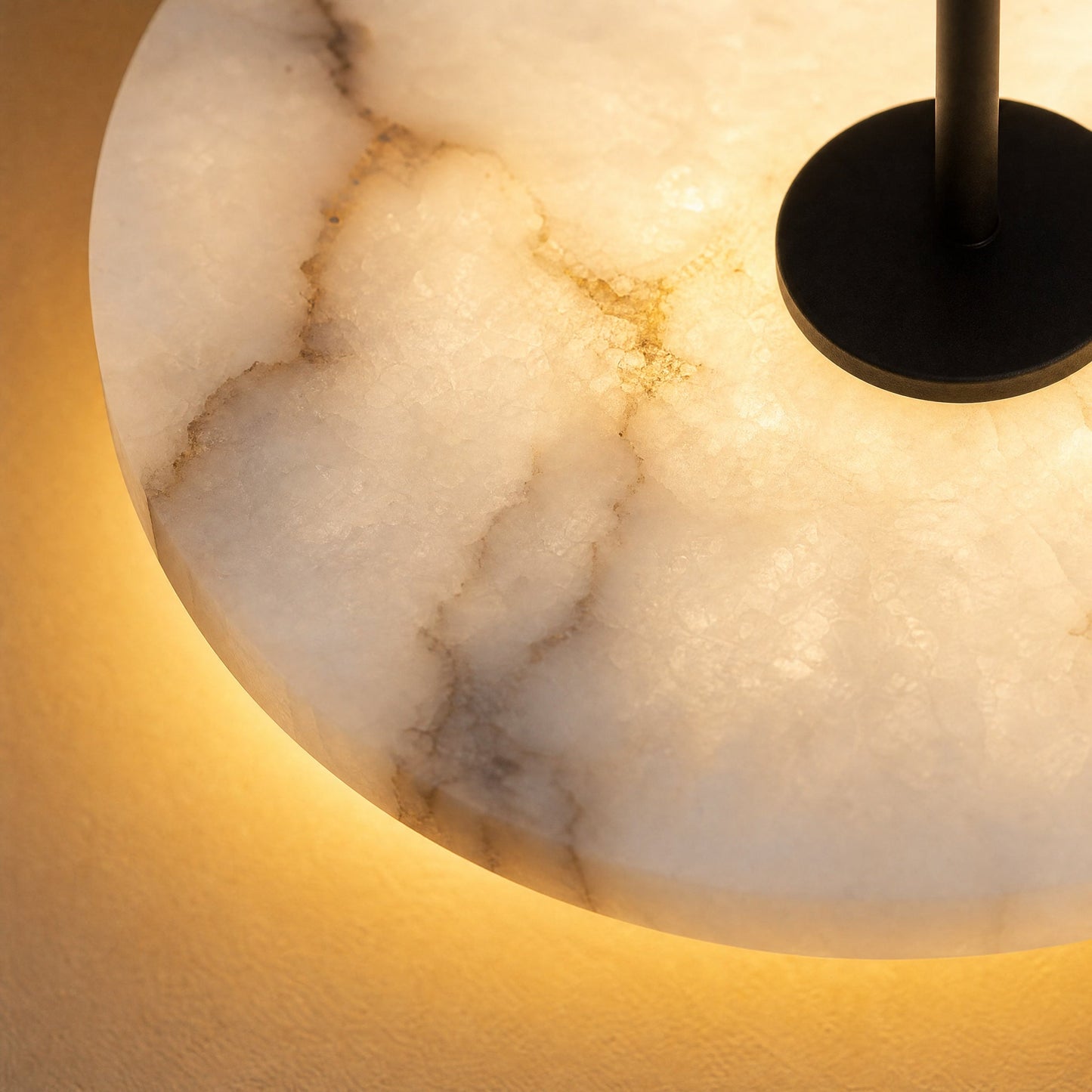 Detail of the natural marble on the Henin wall light, translucent under warm light | Wickleigh