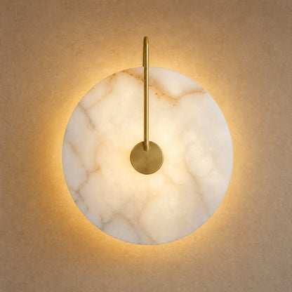 Henin marble wall light, Ø 25 cm disc on gold arm, lit | Wickleigh