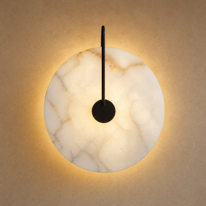 Henin marble wall light, Ø 25 cm disc on black arm, lit | Wickleigh