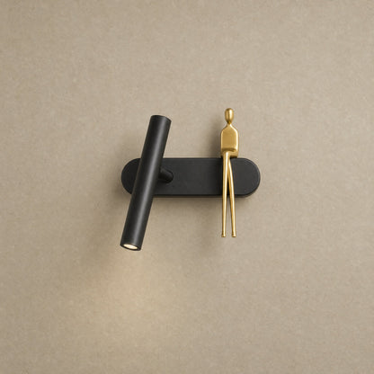 Odron black and gold adjustable wall light with little seated figure, packshot | Wickleigh