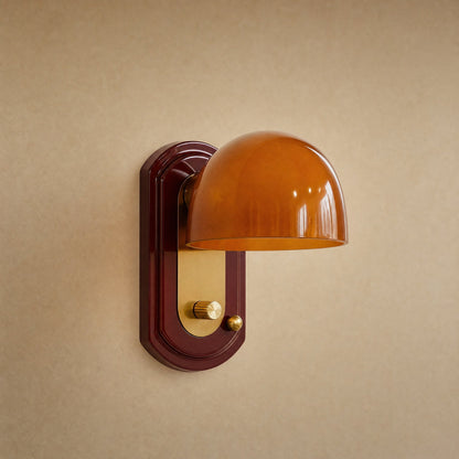 Elmen bedside wall light, amber glass dome on bordeaux lacquer plate with polished brass | Wickleigh