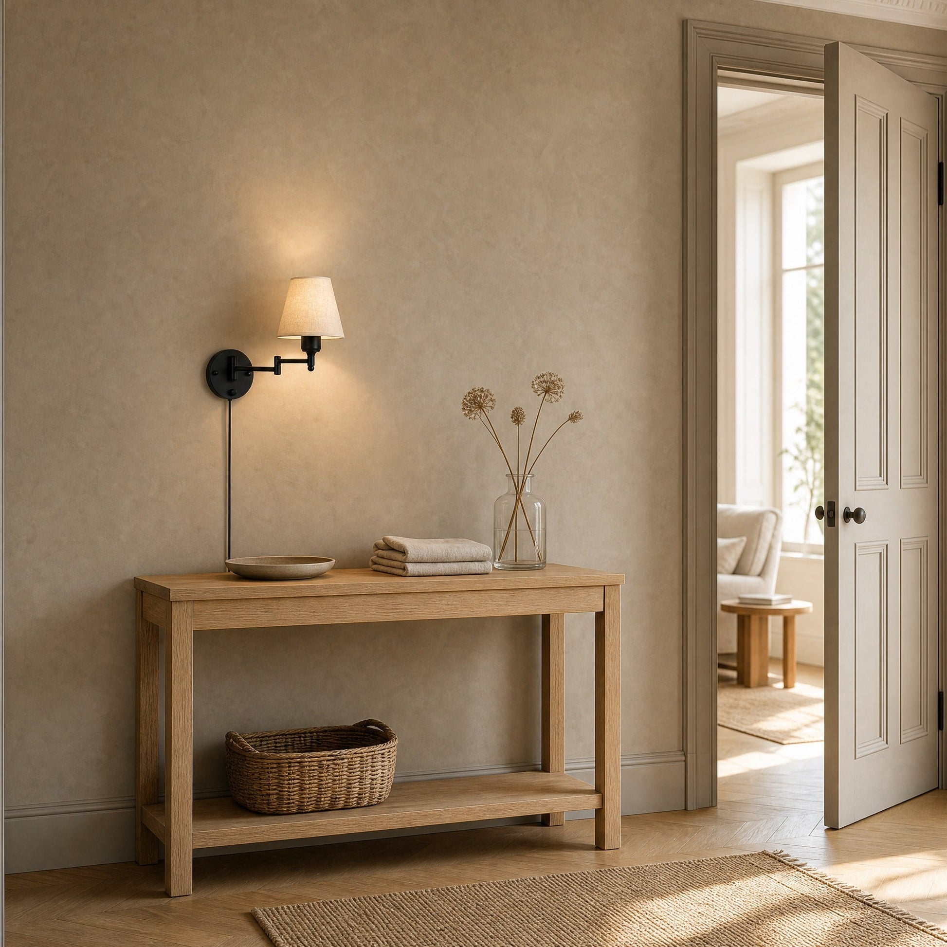 Runen fabric wall reading light lit above an oak console table in an entrance | Wickleigh
