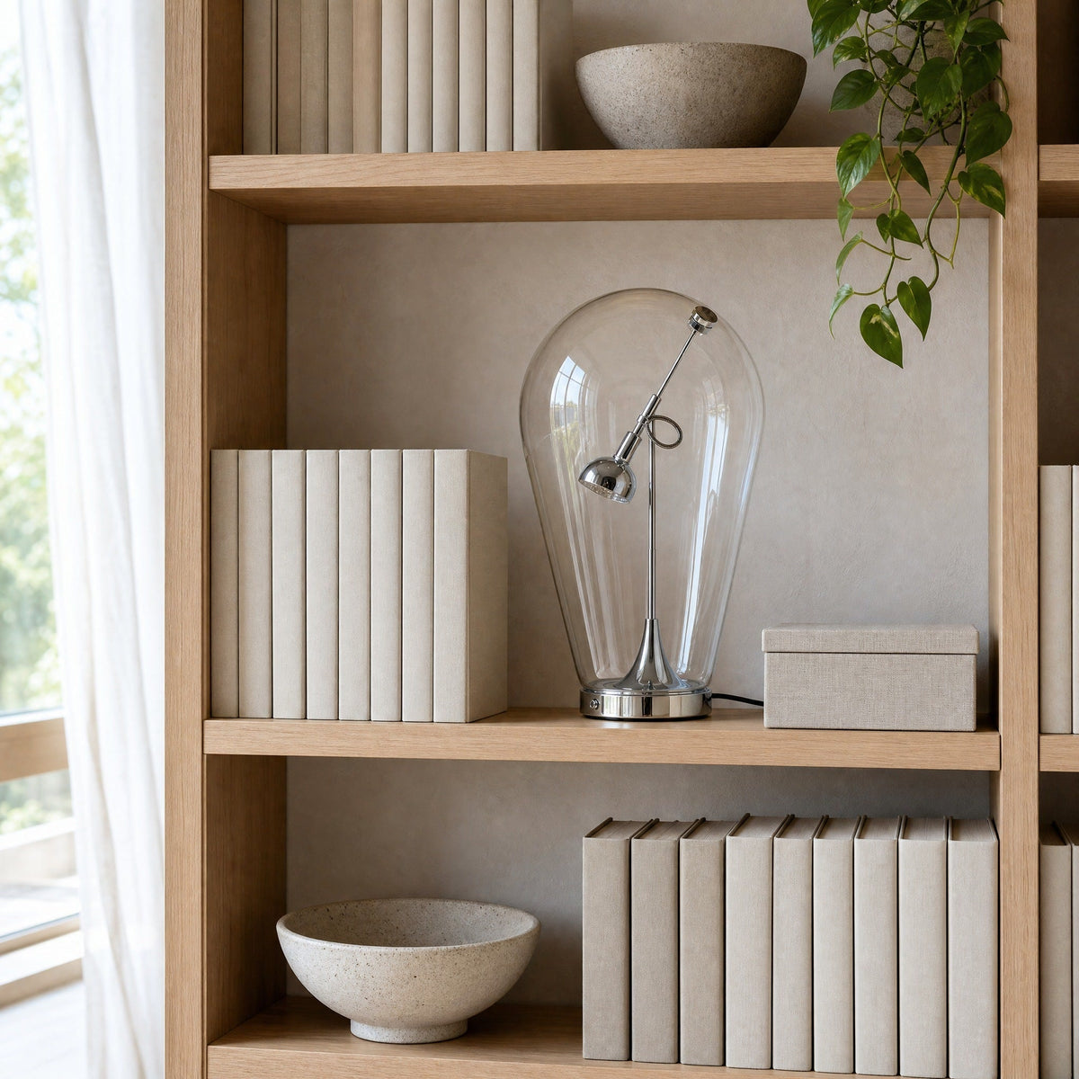 Alrin chrome lamp on a Japandi-style bookshelf in daylight | Wickleigh