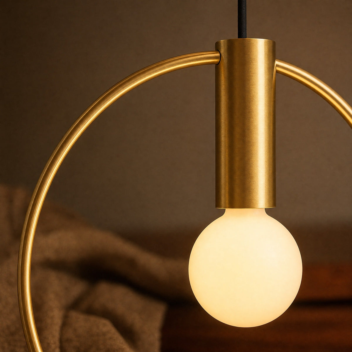 Detail of the brushed brass ring and lit opal globe on the Heden pendant light | Wickleigh