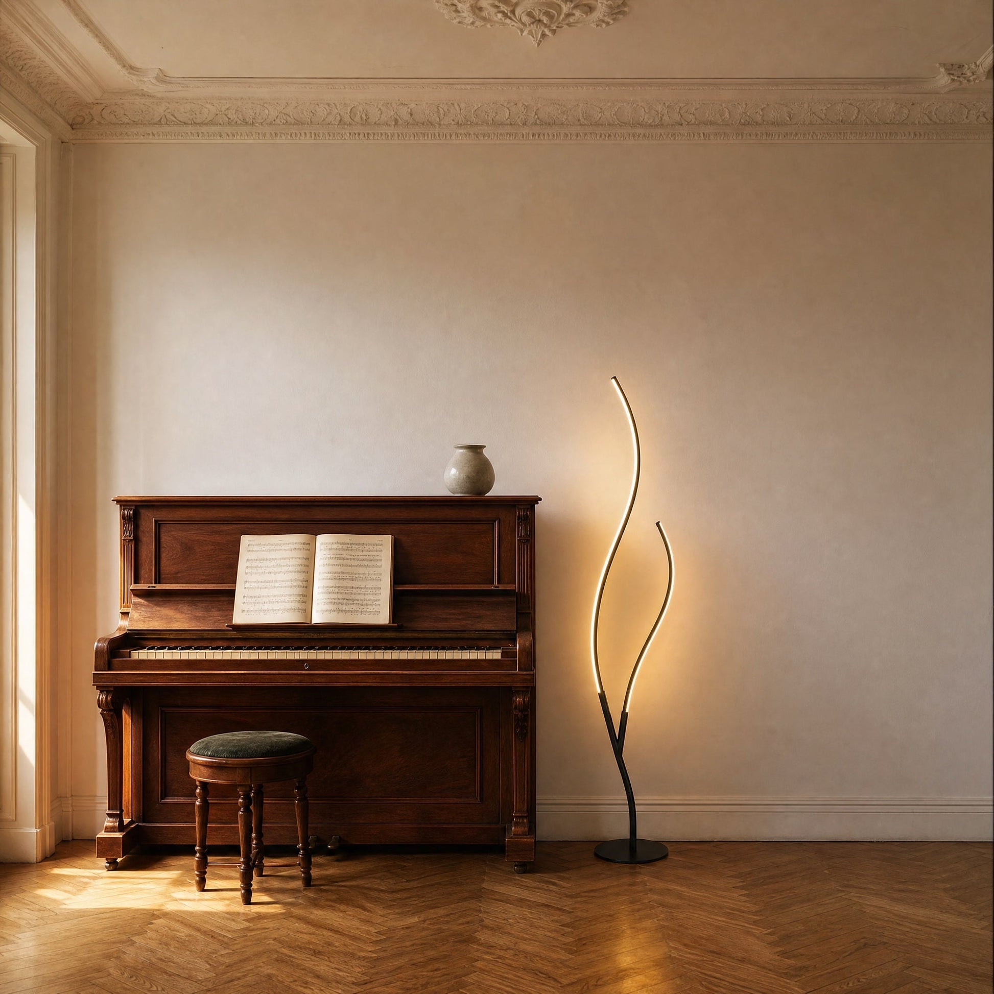 Eyrra matt black LED floor lamp beside an upright piano in a period sitting room | Wickleigh