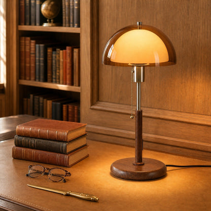 Close-up of the Sorlin amber dome table lamp lit on a tan leather desktop | Wickleigh