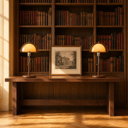 Two Sorlin amber dome table lamps lined up on a library console | Wickleigh