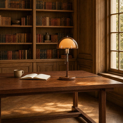 Sorlin amber dome table lamp on a library table in daylight | Wickleigh