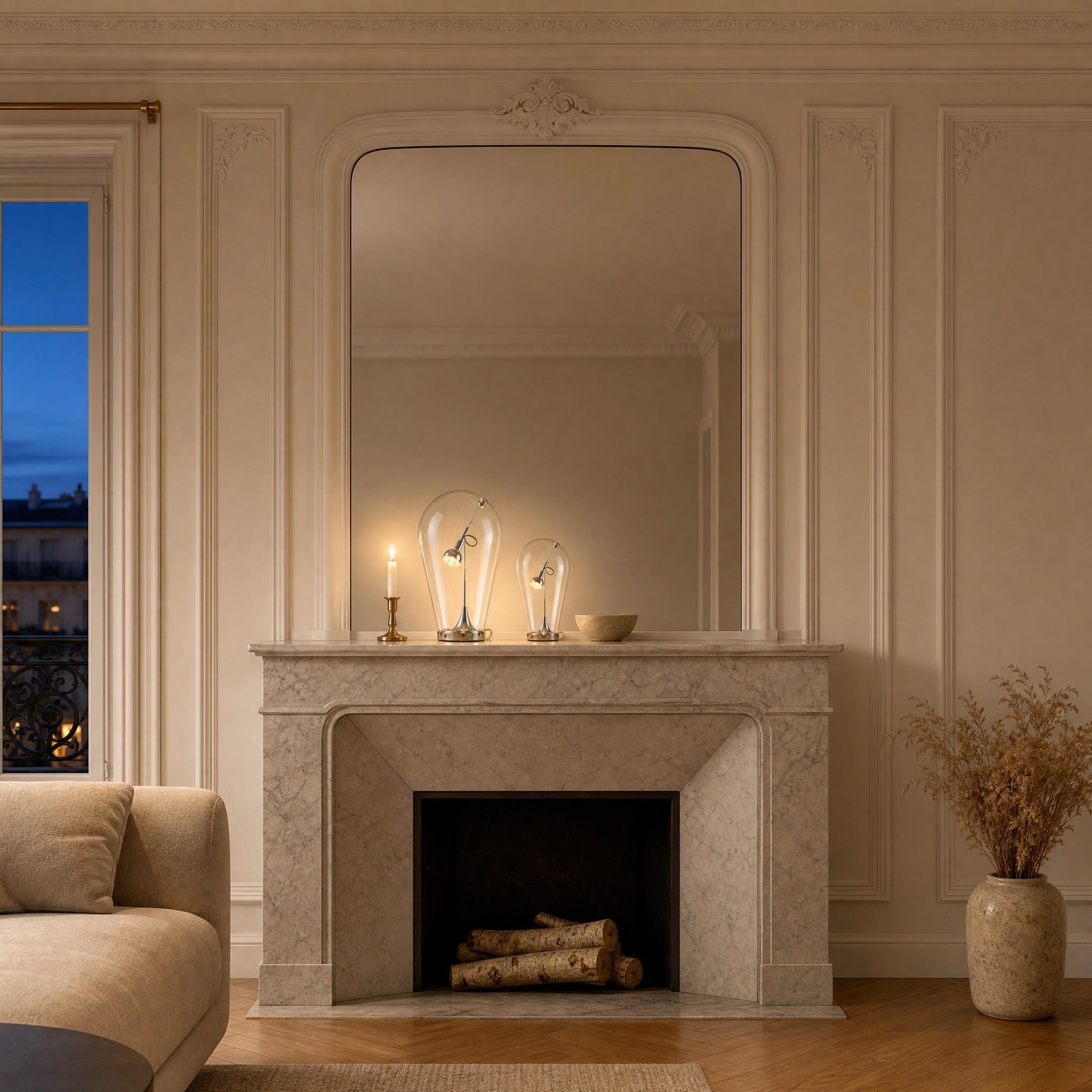 A pair of Alrin chrome lamps lit on a marble fireplace mantel | Wickleigh