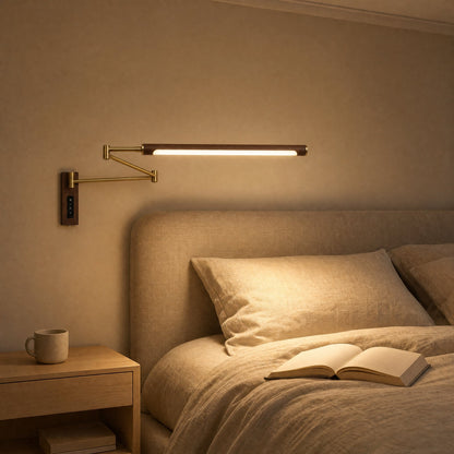 Vinra wall light lit above a bedhead, warm evening atmosphere | Wickleigh
