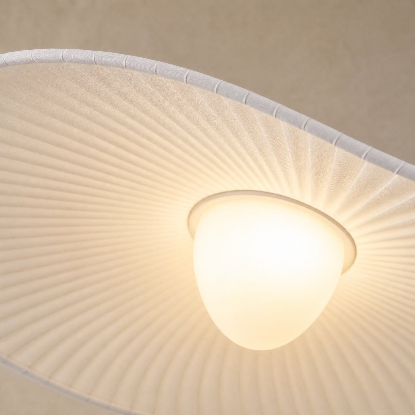 Detail of the Urven pleated fabric veil lit, bound hem and white oval diffuser | Wickleigh