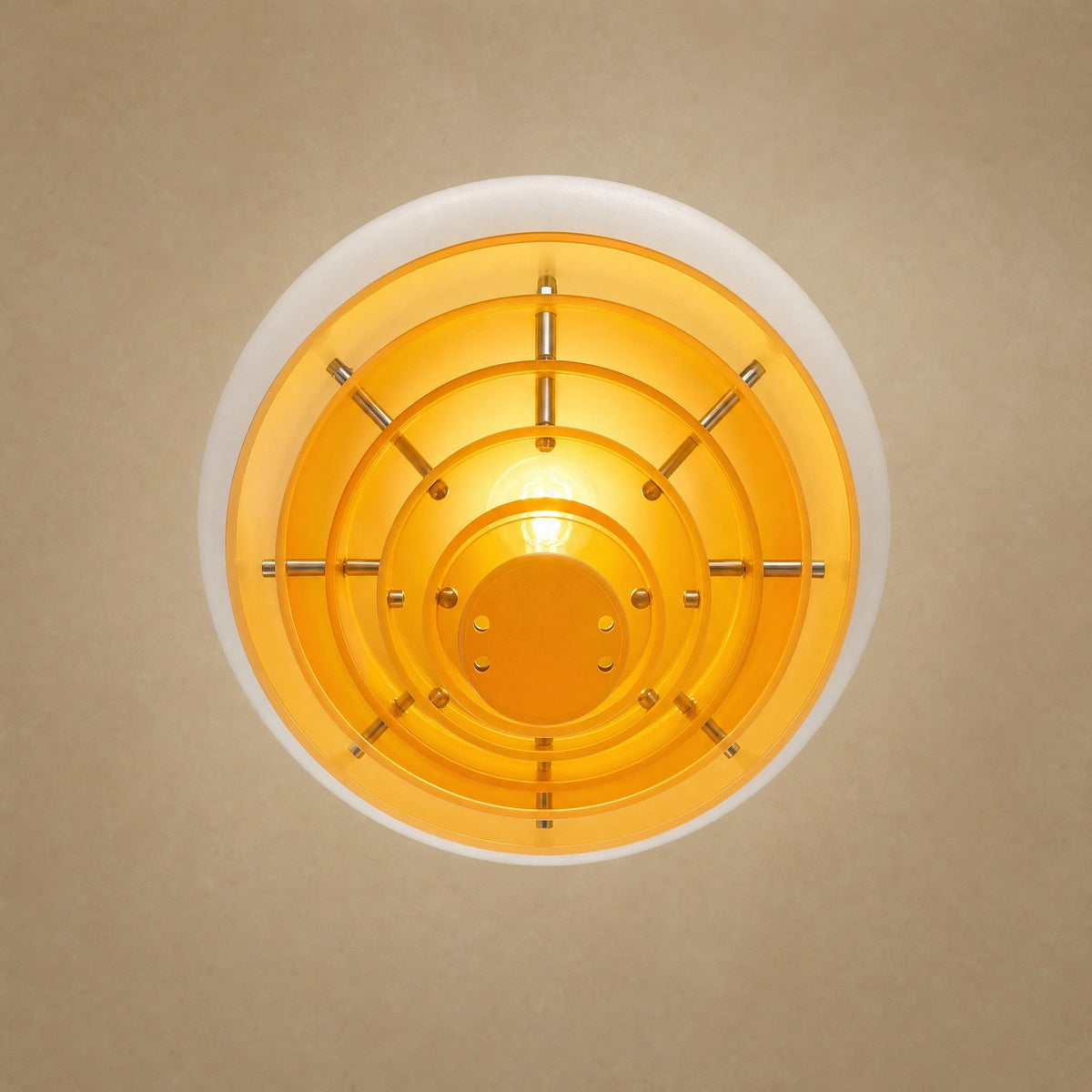 Fenwyn orange pendant light seen from below, six concentric amber discs and E27 bulb | Wickleigh