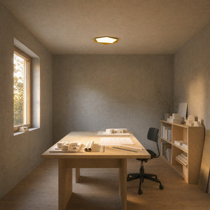 Ostin yellow flat ceiling light lit above a birch work table | Wickleigh