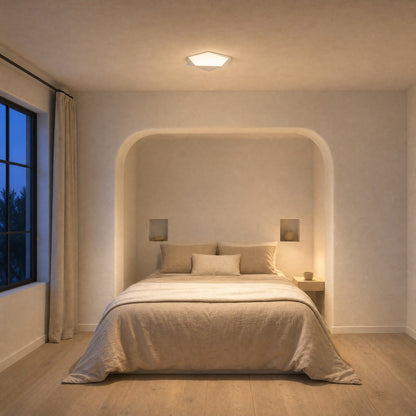 Ostin white flat ceiling light lit above a bed in a plaster alcove | Wickleigh