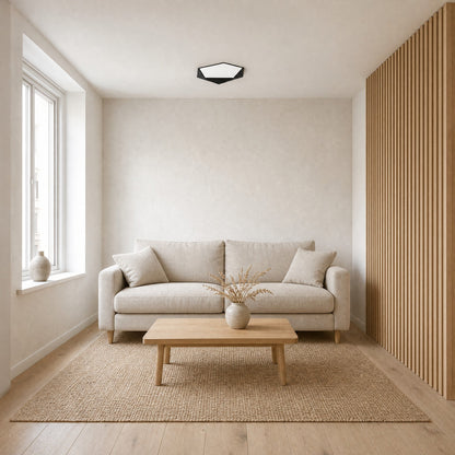 Ostin black flat ceiling light in a small Nordic sitting room with a light oak screen | Wickleigh