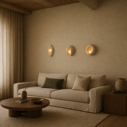 Three Savlin shells aligned and lit above a linen sofa in a japandi living room | Wickleigh