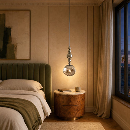 Kolna art deco pendant light lit above a bedside table in a green velvet bedroom | Wickleigh