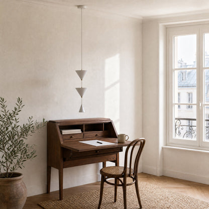 Silna white pendant light, unlit, above a walnut writing desk, daylight office corner | Wickleigh