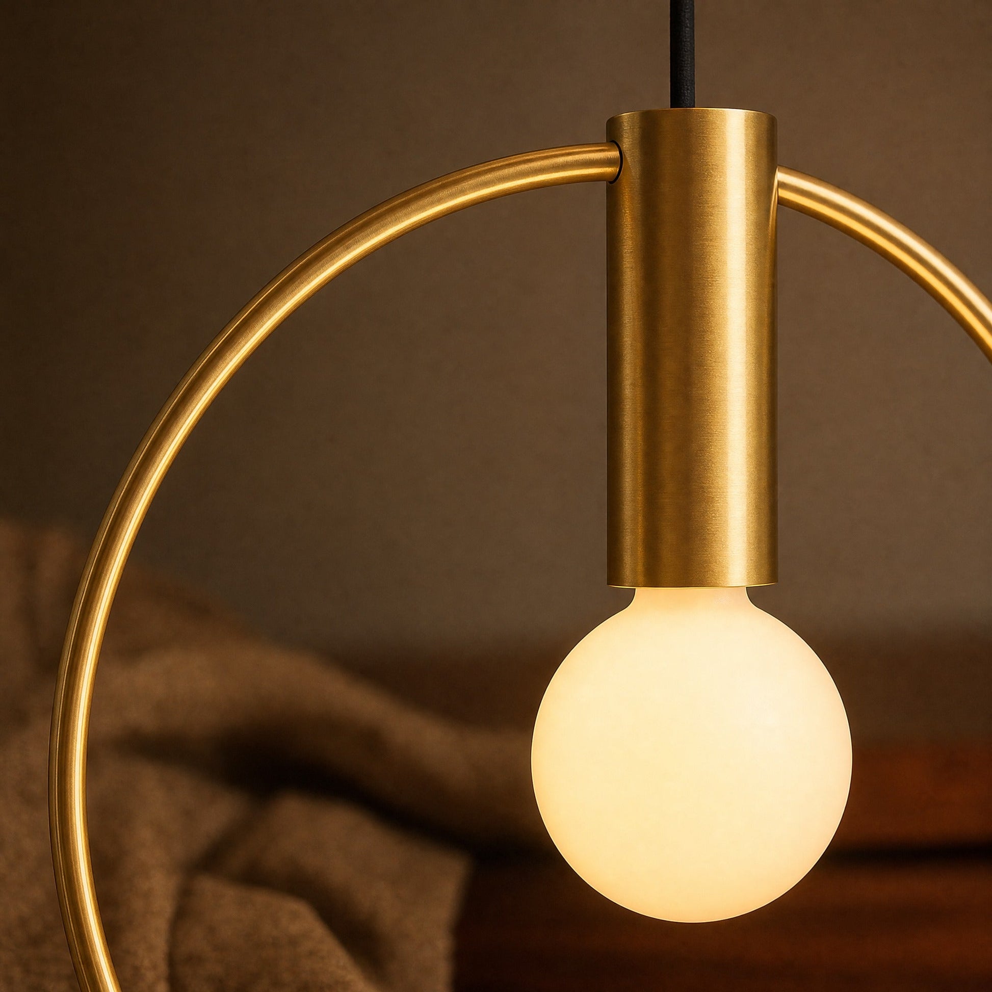 Detail of the brushed brass ring and lit opal globe on the Heden pendant light | Wickleigh