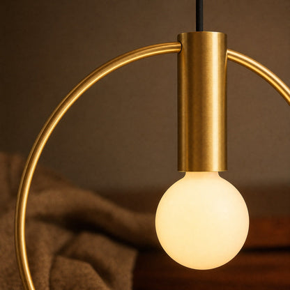 Detail of the brushed brass ring and lit opal globe on the Heden pendant light | Wickleigh