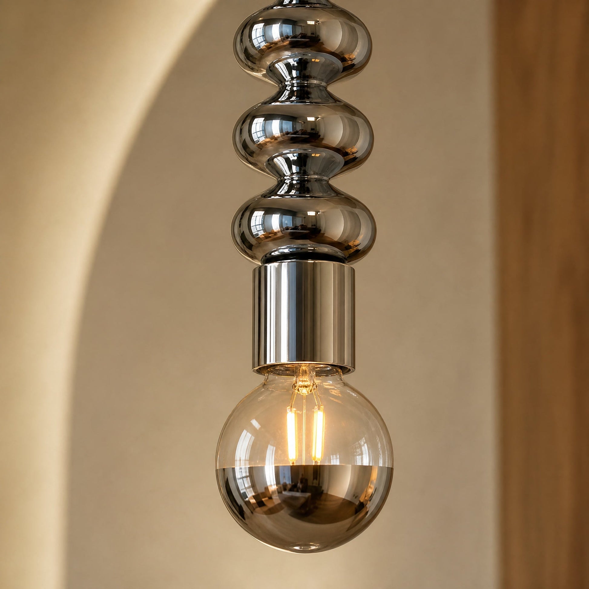 Detail of the chrome beads and lit half-mirror globe on the Kavlin pendant light | Wickleigh