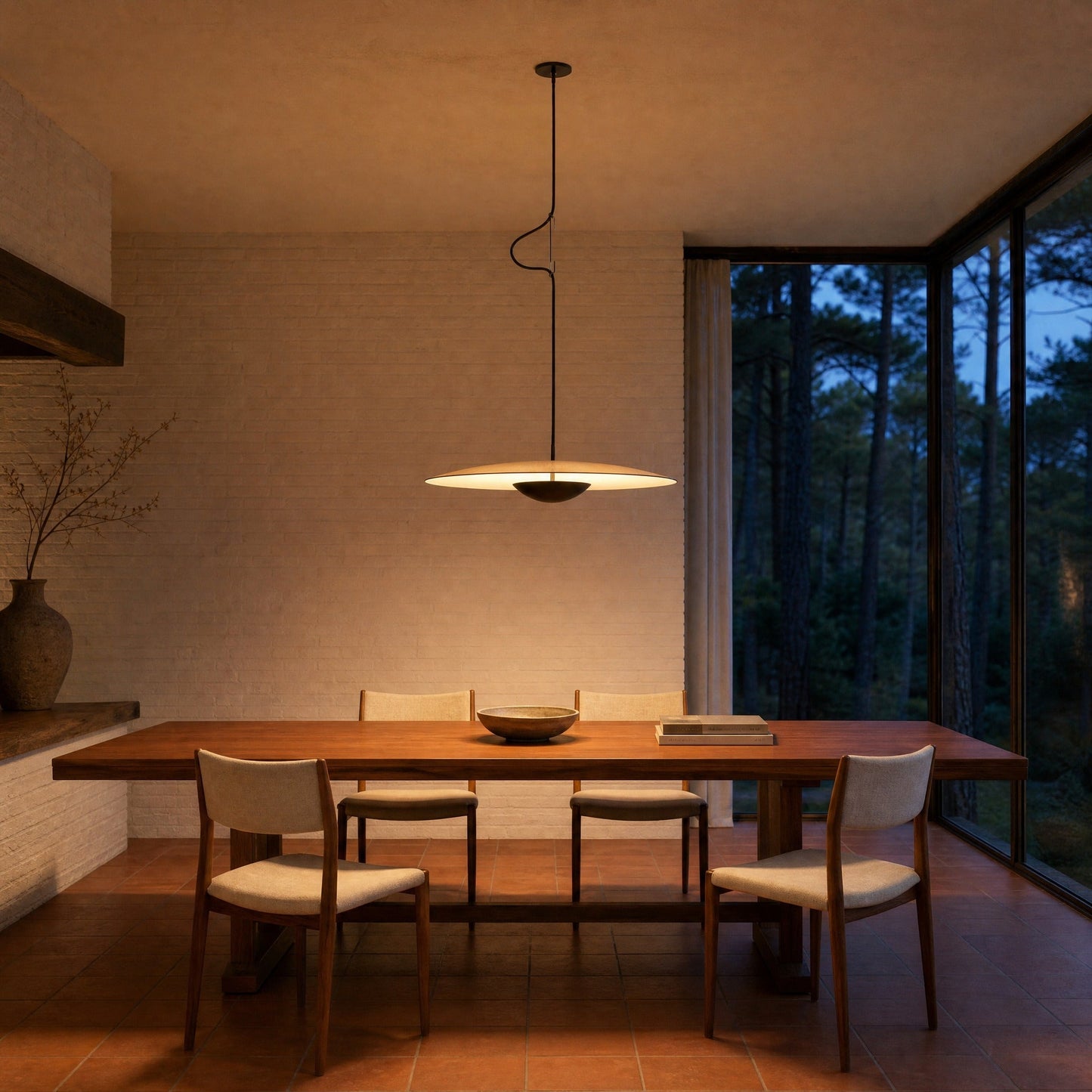 Fenna wood-effect pendant light switched on above a teak table in an architect's dining room | Wickleigh