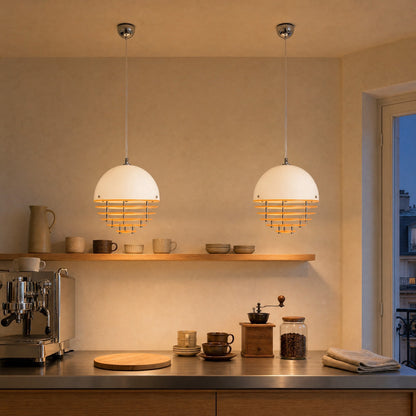 Two Fenwyn orange pendant lights aligned and lit above a brushed steel counter | Wickleigh